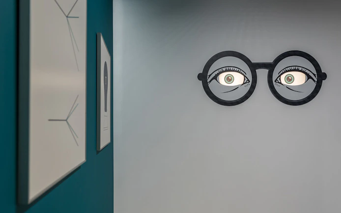 Wall art with optical illusion of eyes in glasses at Museum of Illusions, Thessaloniki.