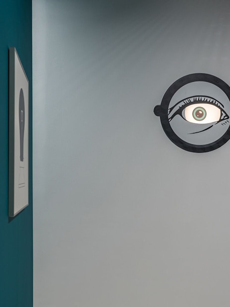 Wall art with optical illusion of eyes in glasses at Museum of Illusions, Thessaloniki.