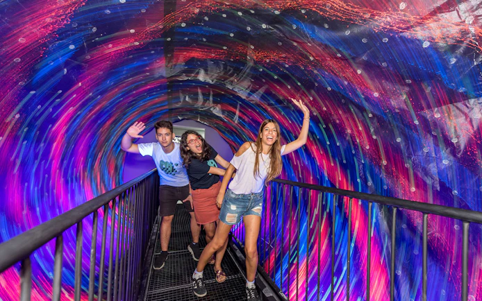 Visitors enjoying the vortex tunnel at Museum of Illusions, Thessaloniki.
