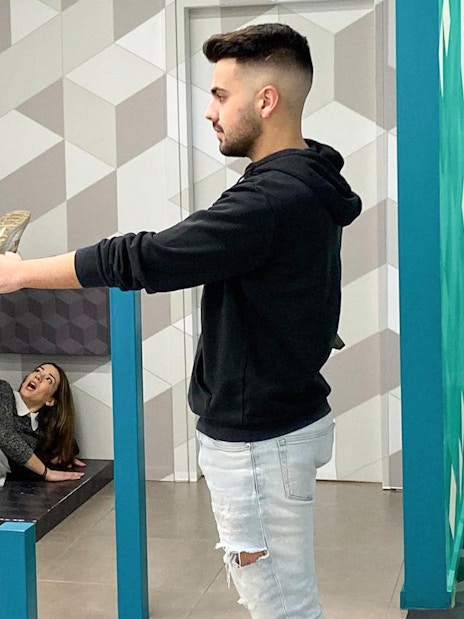 Man and woman interacting with optical illusion exhibit at Museum of Illusions, Thessaloniki.