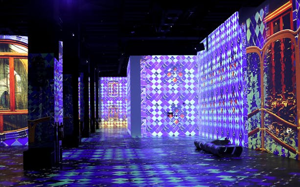 Infinity des Lumières exhibit with vibrant digital art projections of Gaudi, Kandinsky, and Klee.