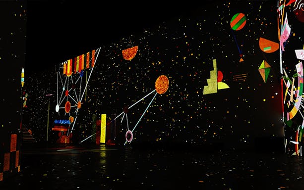 Infinity des Lumières exhibit featuring abstract art projections by Gaudi, Kandinsky, and Klee.
