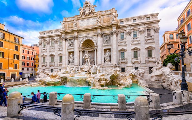Trevi Fountain in Rome with tourists nearby on a central Rome bike tour.