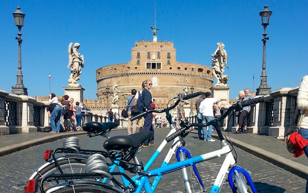 Bicycles on Ponte Sant'Angelo with Castel Sant'Angelo in the background, Central Rome bike tour.