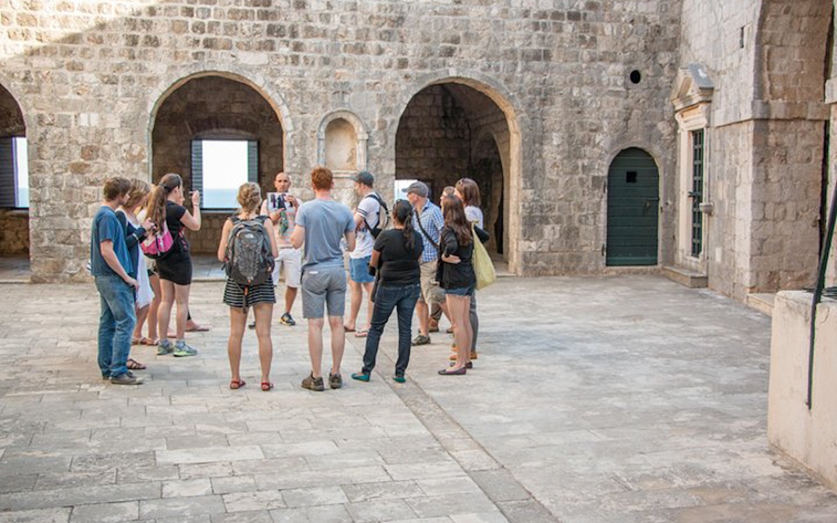 Tour group exploring Dubrovnik's historic walls on a Game of Thrones tour.