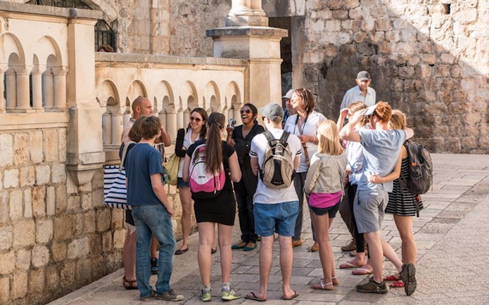 Tour group exploring Dubrovnik's historic walls on Game of Thrones tour.
