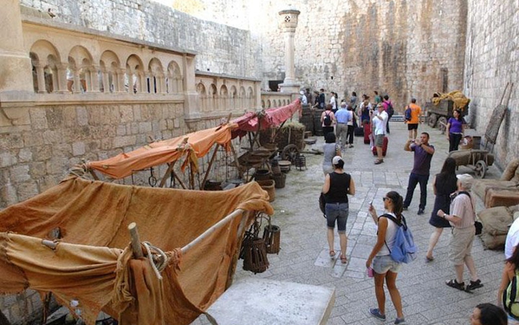 Tourists exploring Dubrovnik's historic walls on a Game of Thrones tour.