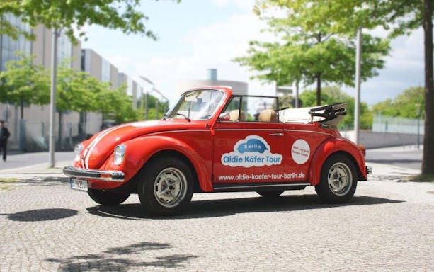 Red VW Käfer Cabrio parked on a Berlin street for a 4-hour discovery tour.