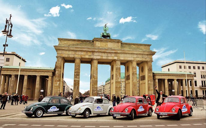 VW Käfer Cabrio tour cars in front of Brandenburg Gate, Berlin.