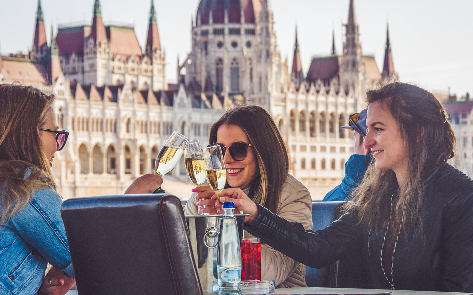 Budapest river cruise with people enjoying unlimited drinks on a party boat.