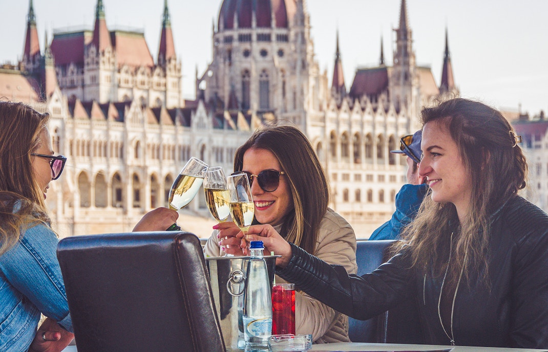 Budapest river cruise with people enjoying unlimited drinks on a party boat.