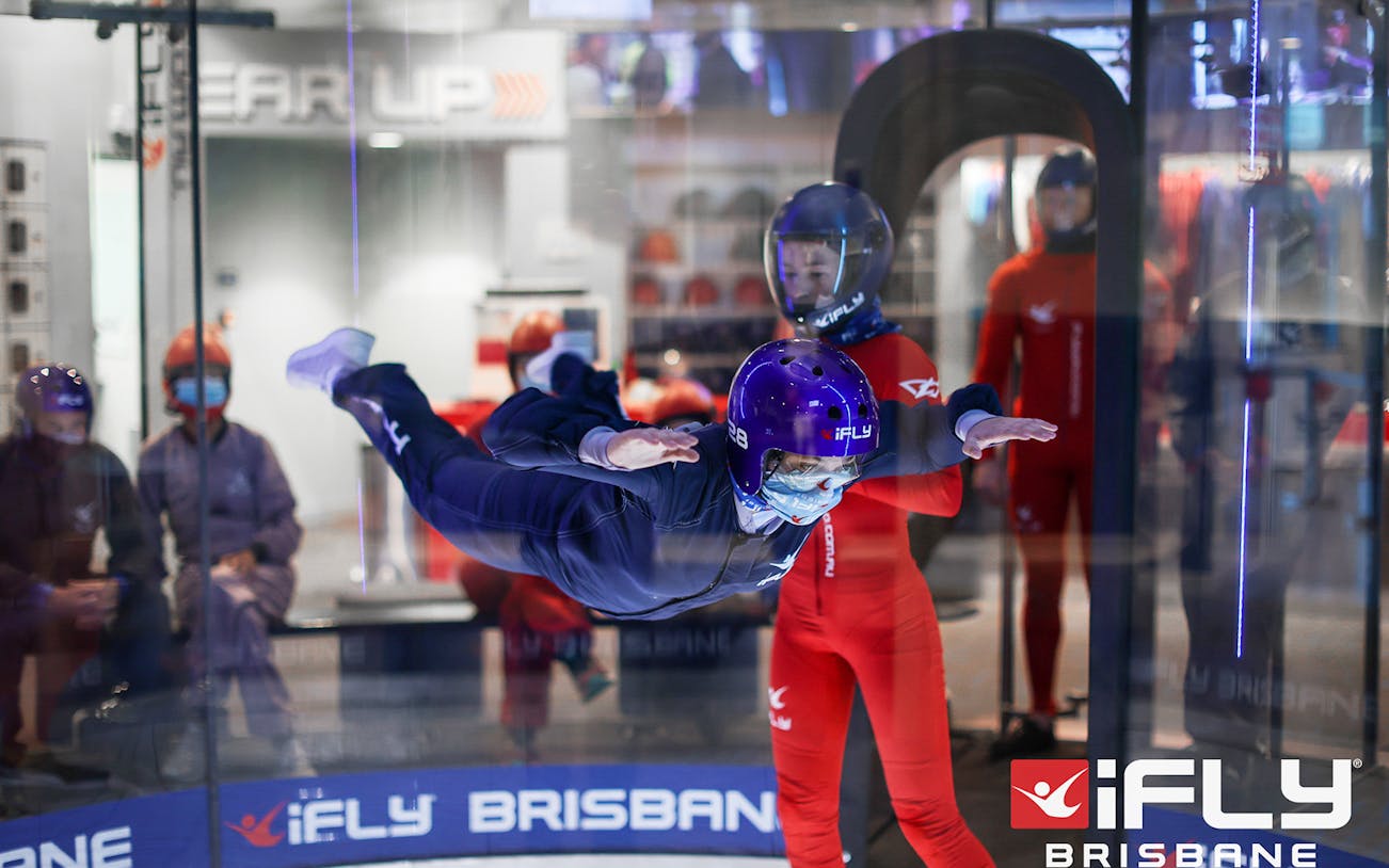 Indoor skydiving at iFly Brisbane with instructor guidance.