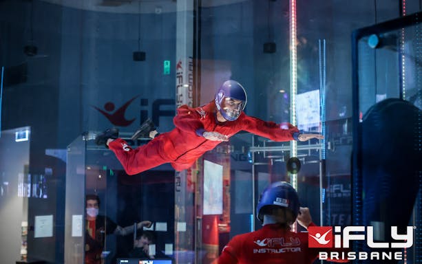 Indoor skydiving at iFly Brisbane with instructor guidance.