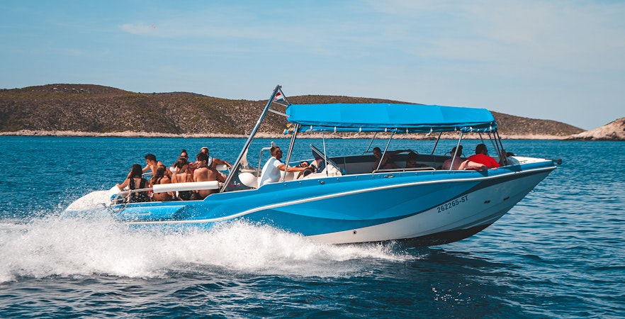 Luxury boat with tourists on Blue Cave and five islands tour, Croatia.