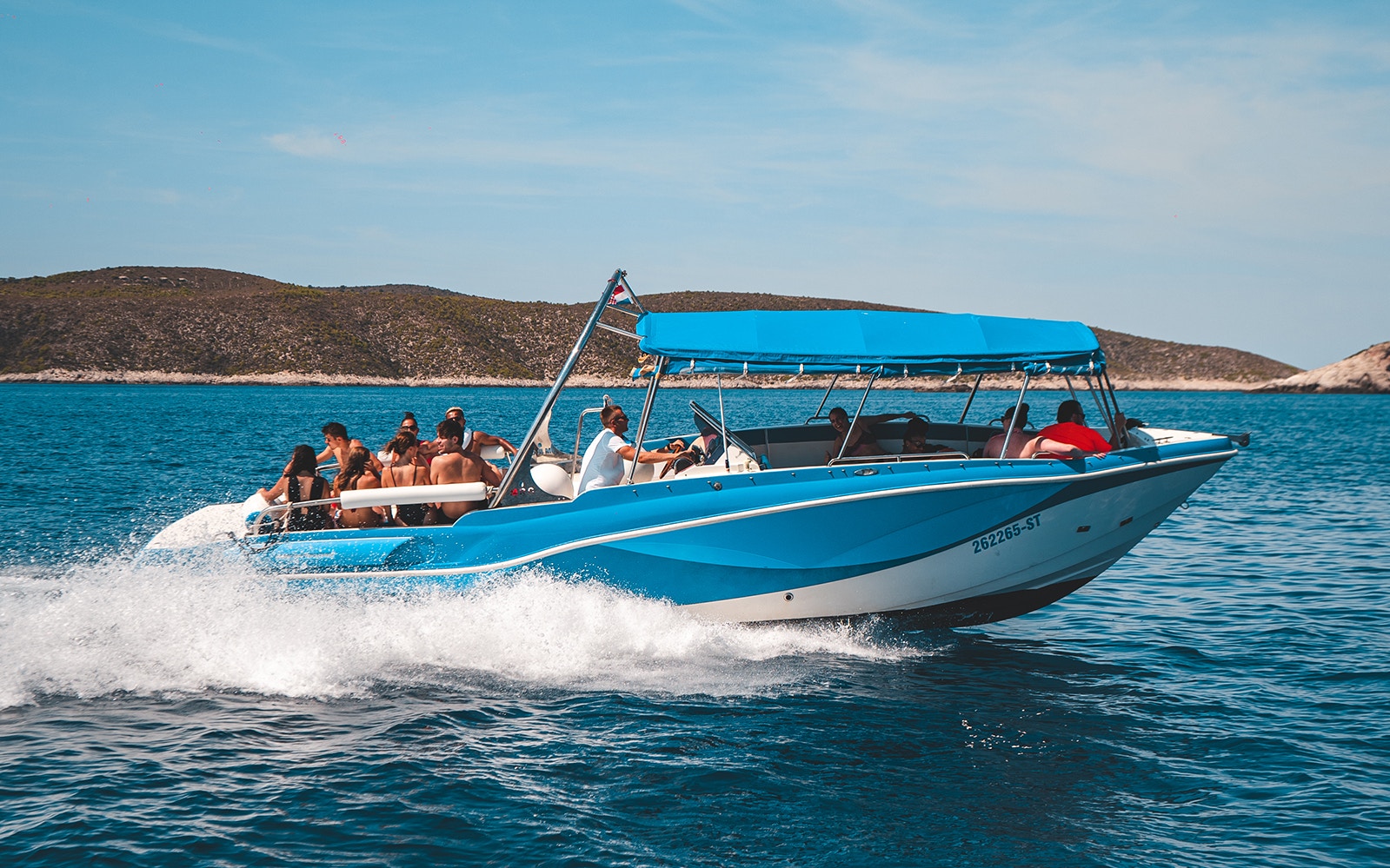 Luxury boat with tourists on Blue Cave and five islands tour, Croatia.