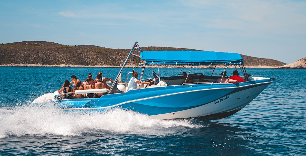 Luxury boat with tourists on Blue Cave and five islands tour, Croatia.