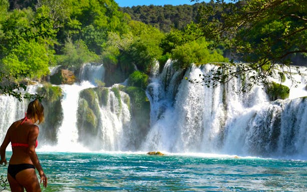 Visitor at Krka Waterfalls, Croatia, enjoying the view during a tour from Split.
