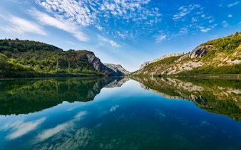 Krka National Park river view with surrounding hills, part of Split tour.