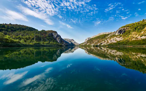 Krka National Park river view with surrounding hills, part of Split tour.