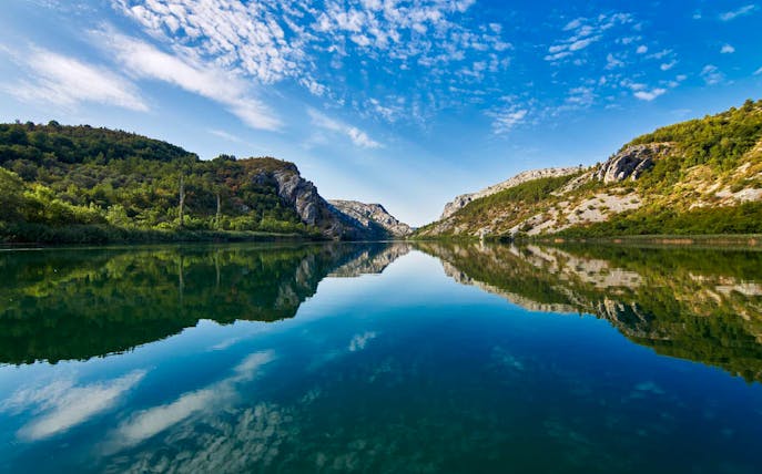 Krka National Park river view with surrounding hills, part of Split tour.