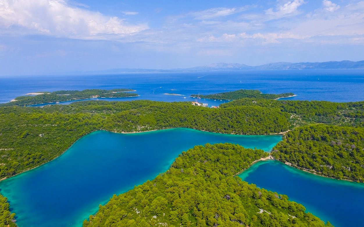 Aerial view of Mljet Island's lush forests and turquoise lakes, Croatia.