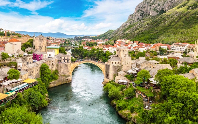 Stari Most bridge over Neretva River in Mostar, Bosnia and Herzegovina, with surrounding town.