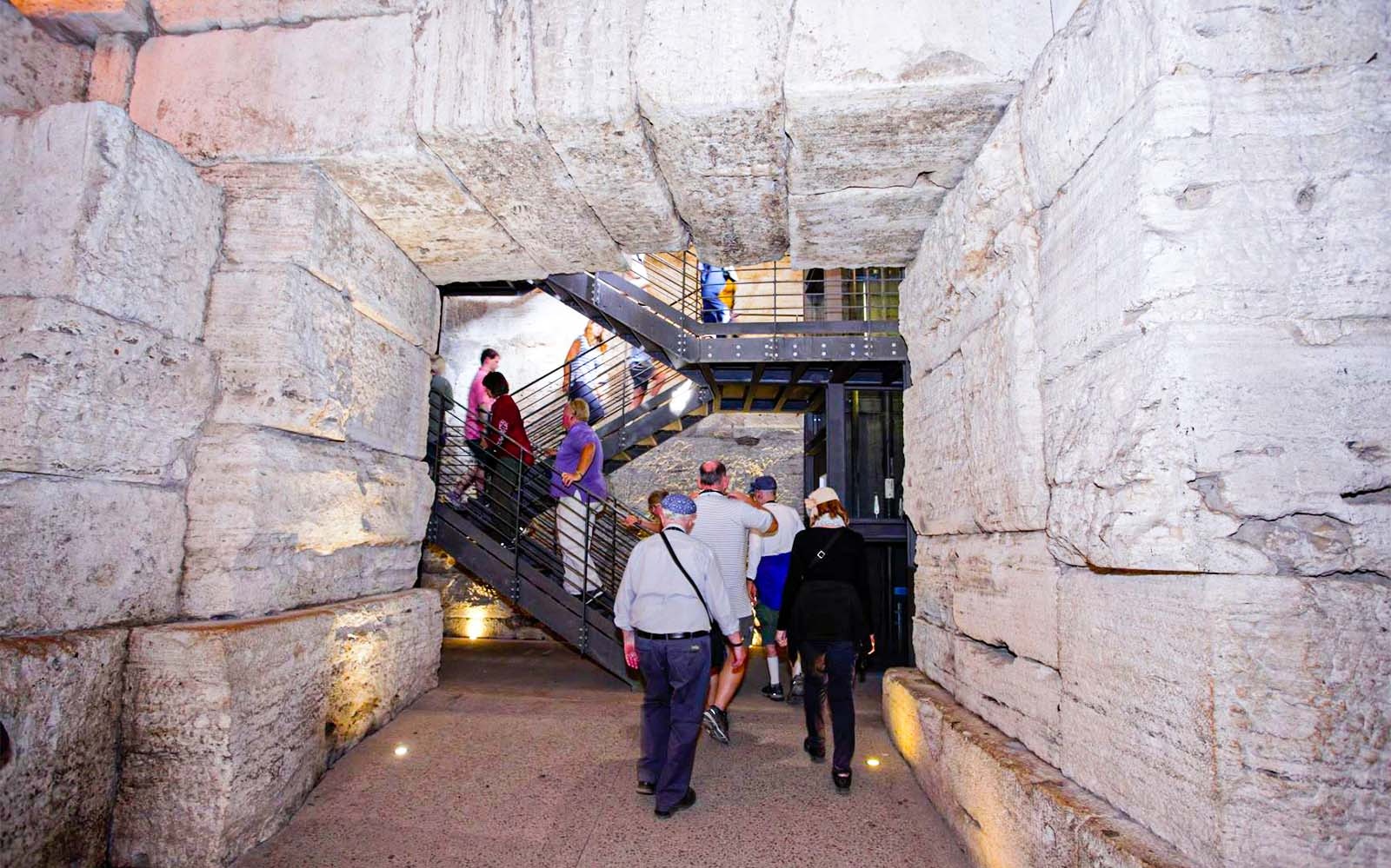 Visitors exploring the underground passage of the Colosseum in Rome.