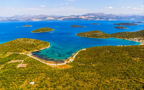 Aerial view of lush green islands and blue waters near Ston and Korcula Island, Croatia.