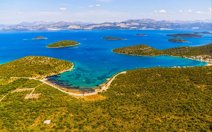 Aerial view of lush green islands and blue waters near Ston and Korcula Island, Croatia.