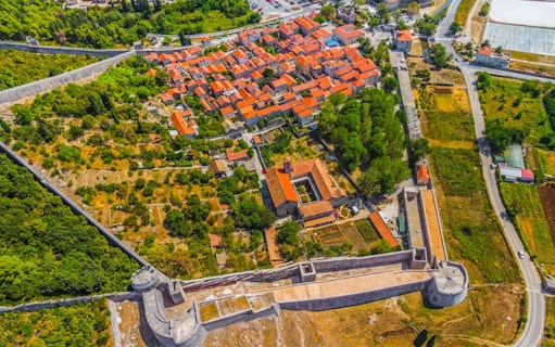 Aerial view of Ston with medieval walls and red-roofed buildings, Croatia.