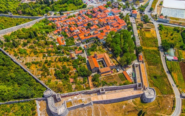 Aerial view of Ston with medieval walls and red-roofed buildings, Croatia.