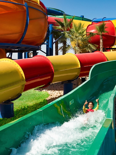Child enjoying water slide at Legoland Water Park, Dubai.