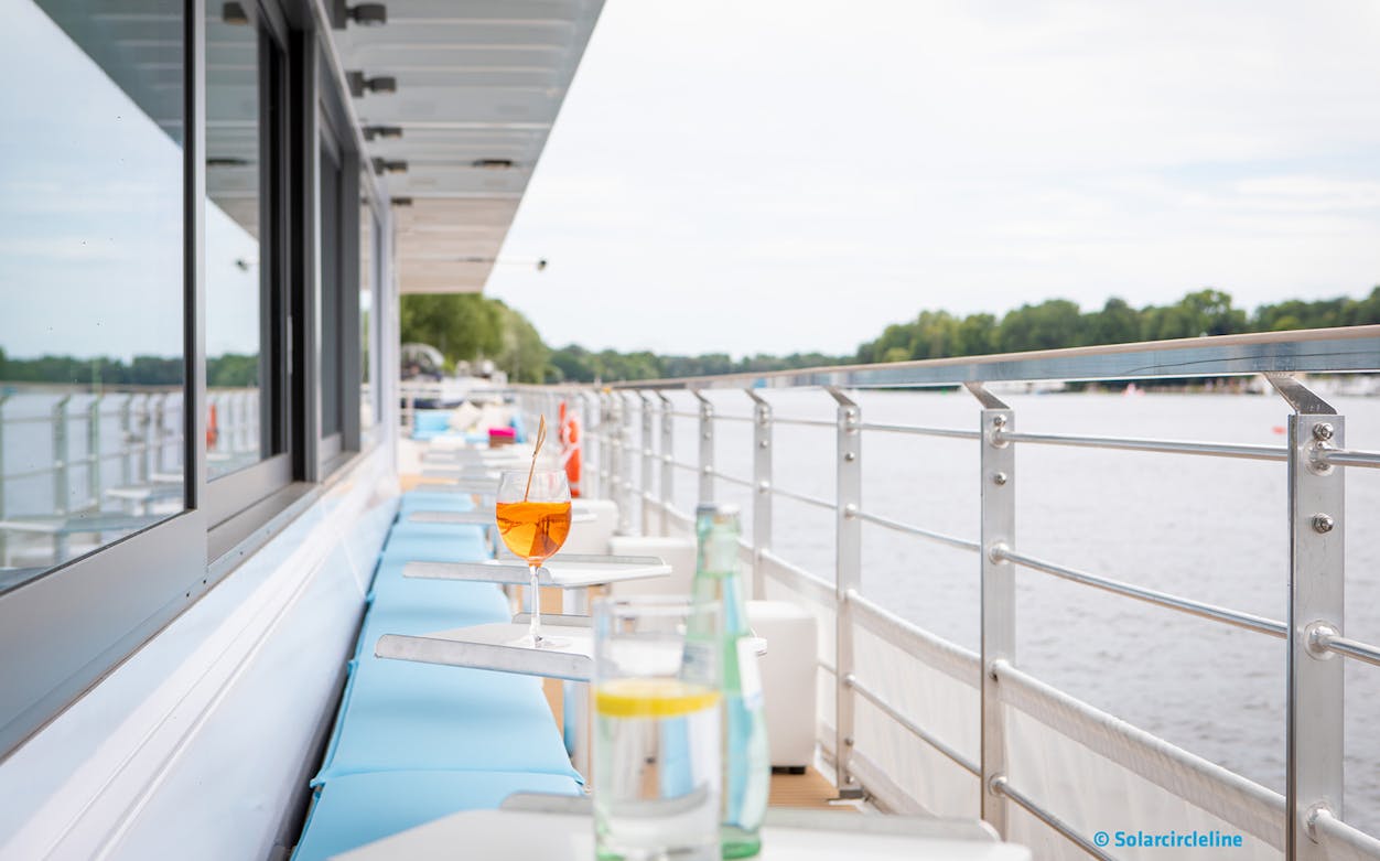Luxury solar catamaran deck with drinks on a river cruise from Jannowitzbrücke.