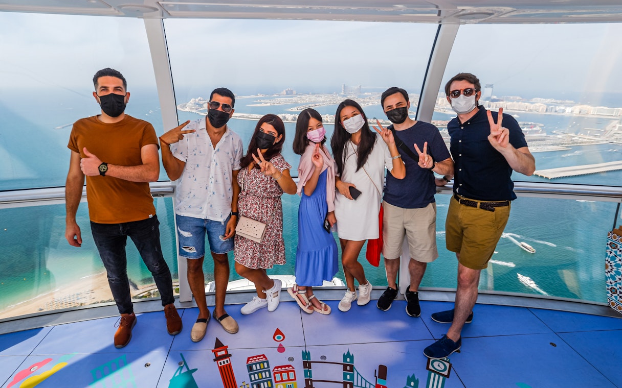 Group enjoying panoramic view from Ain Dubai observation wheel.