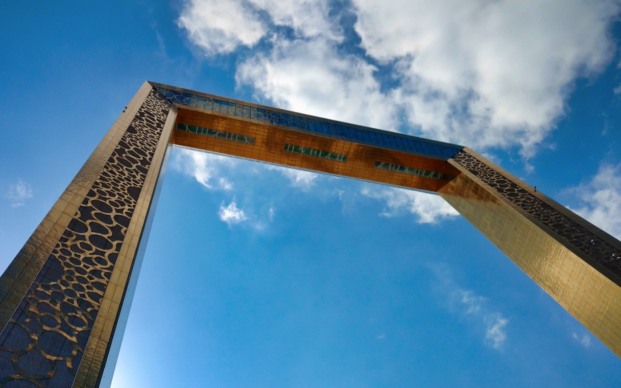 Dubai Frame against a blue sky, part of the Combo: BOLLYWOOD PARKS™ + Dubai Aquarium & Underwater Zoo tour.