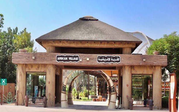 Entrance to African Village at Dubai Safari Park, featuring traditional architecture.