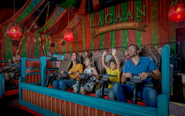 Visitors enjoying a ride at Bollywood Parks Dubai, Lagaan-themed attraction.