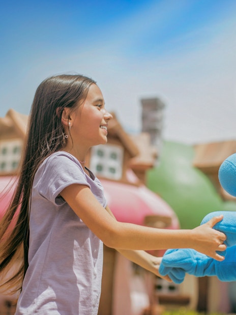 Girl interacting with a Smurf character at MOTIONGATE™ Dubai.