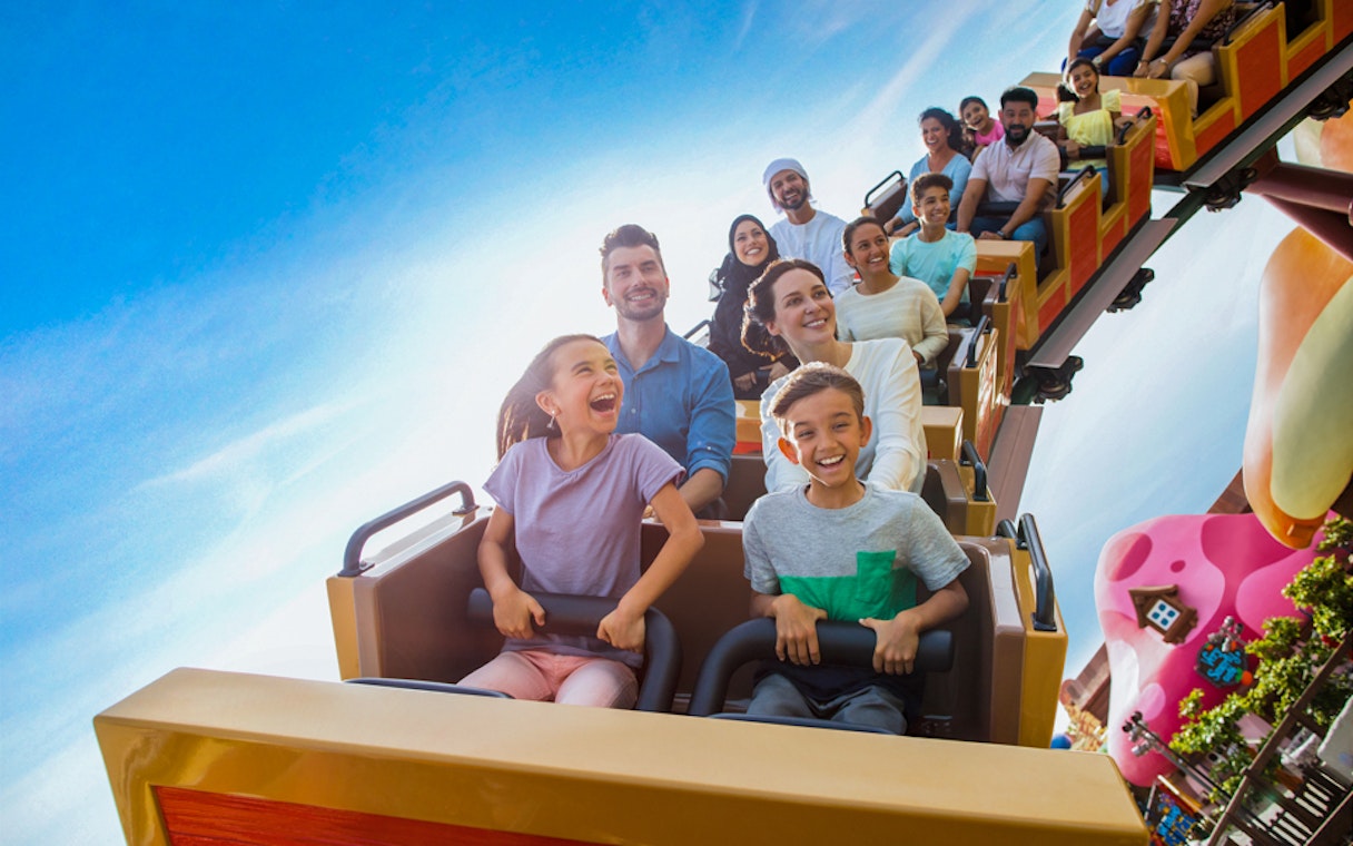 Visitors enjoying a roller coaster ride at MOTIONGATE™ Dubai theme park.