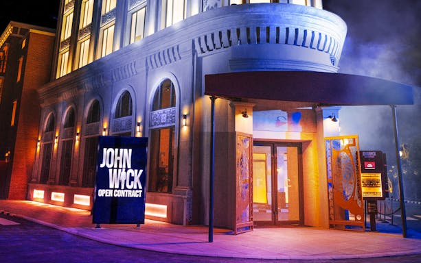 Entrance to John Wick attraction at MOTIONGATE™ Dubai, featuring illuminated sign.