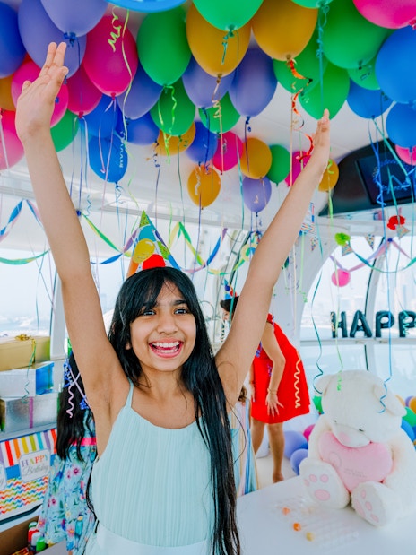 Celebration inside Ain Dubai cabin with balloons and gifts.