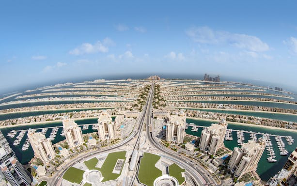 Aerial view of Palm Jumeirah in Dubai at sunrise, seen from The View at the Palm.