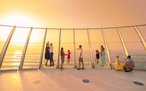 Visitors enjoying sunrise views at The View at the Palm observation deck.