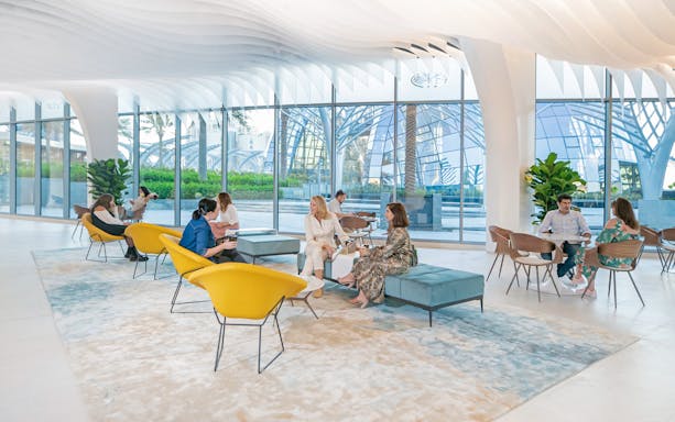 Guests enjoying breakfast at The View at the Palm, Dubai, with modern architecture in the background.