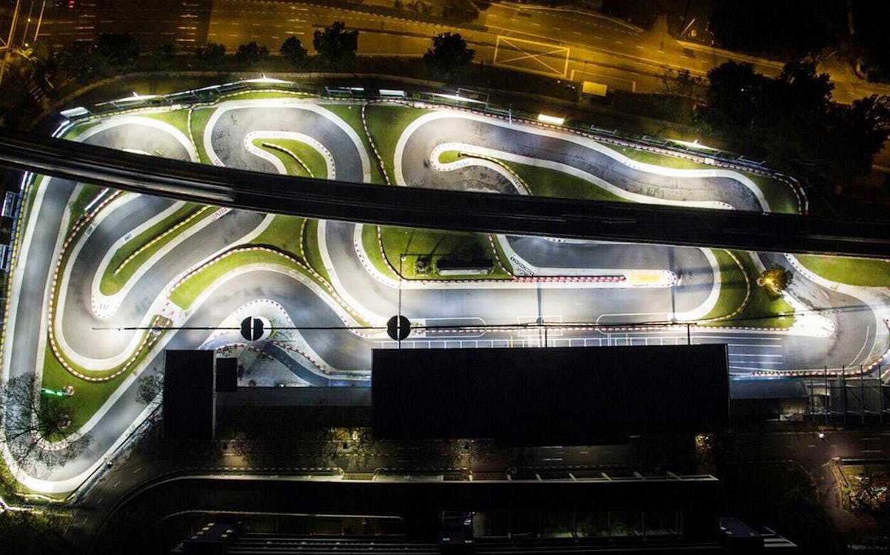 Kranji Fun Kart track in Singapore illuminated at night, showcasing winding paths for 30kph or 50kph rides.