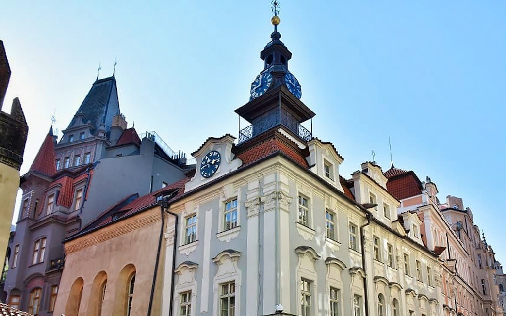 Prague Jewish Town Hall with clock tower under clear sky.