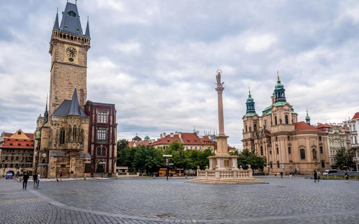 Prague Old Town Square with Astronomical Clock and St. Nicholas Church.
