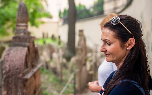 Visitor exploring the historic Jewish Cemetery in Prague.