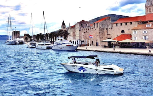 Split Riviera sunset cruise with view of coastal cityscape and Adriatic Sea.