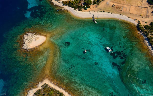 Vis Budikovac island view during Split Riviera sunset sightseeing cruise.
